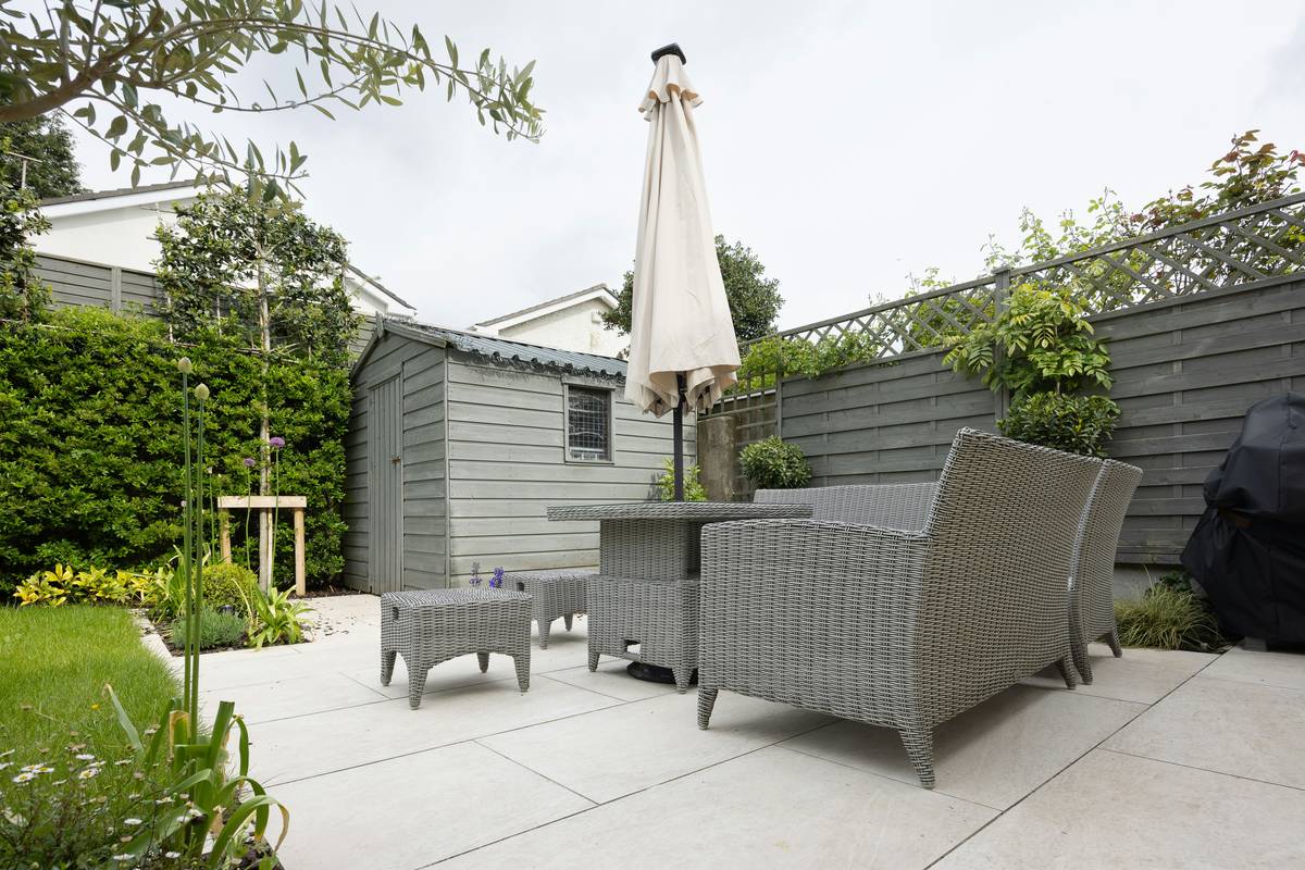 Modern aluminum garden table surrounded by potted plants as ideas for a garden
