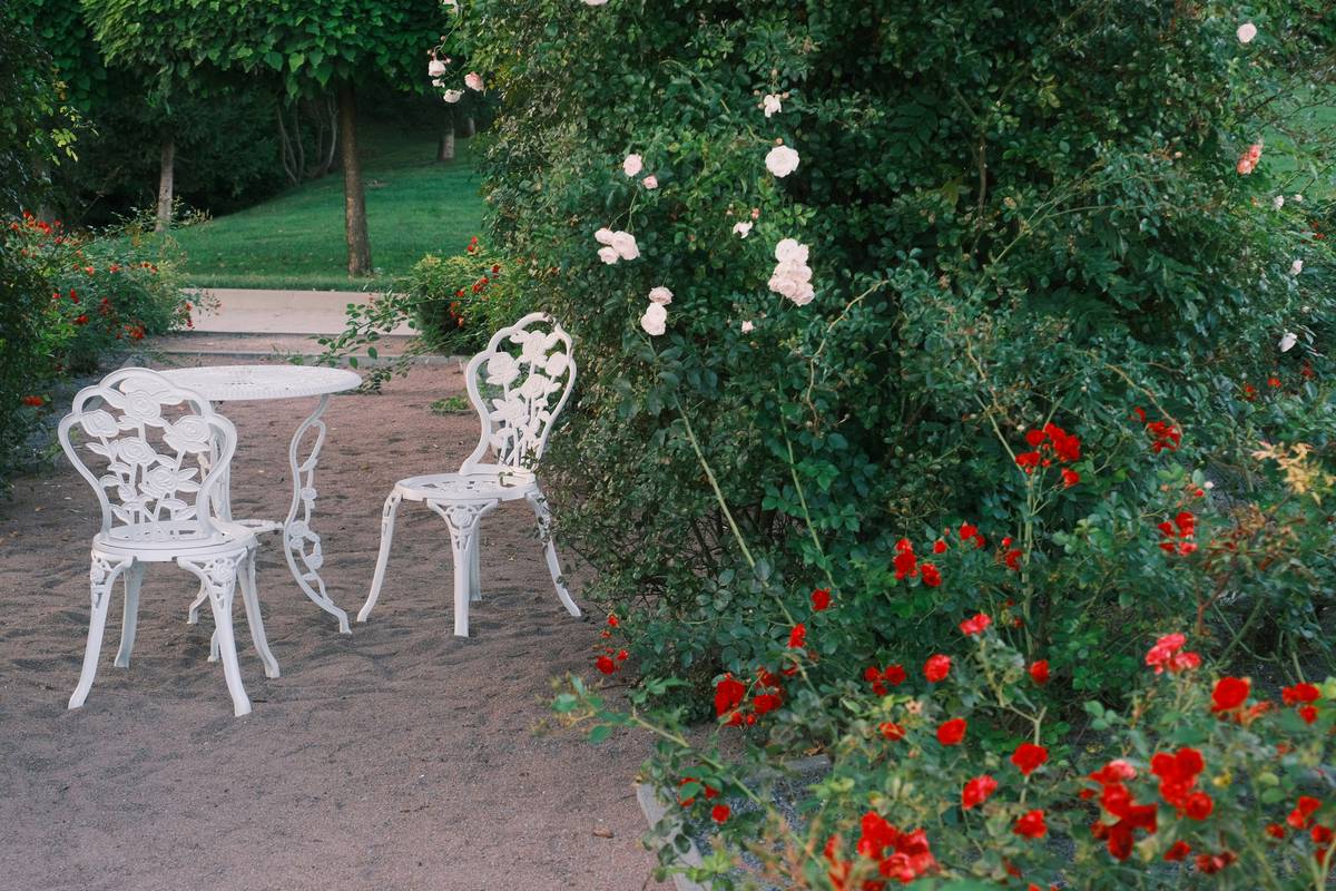 garden gardening ideas showcasing a colorful recycled plastic garden table with mismatched chairs and hanging ferns