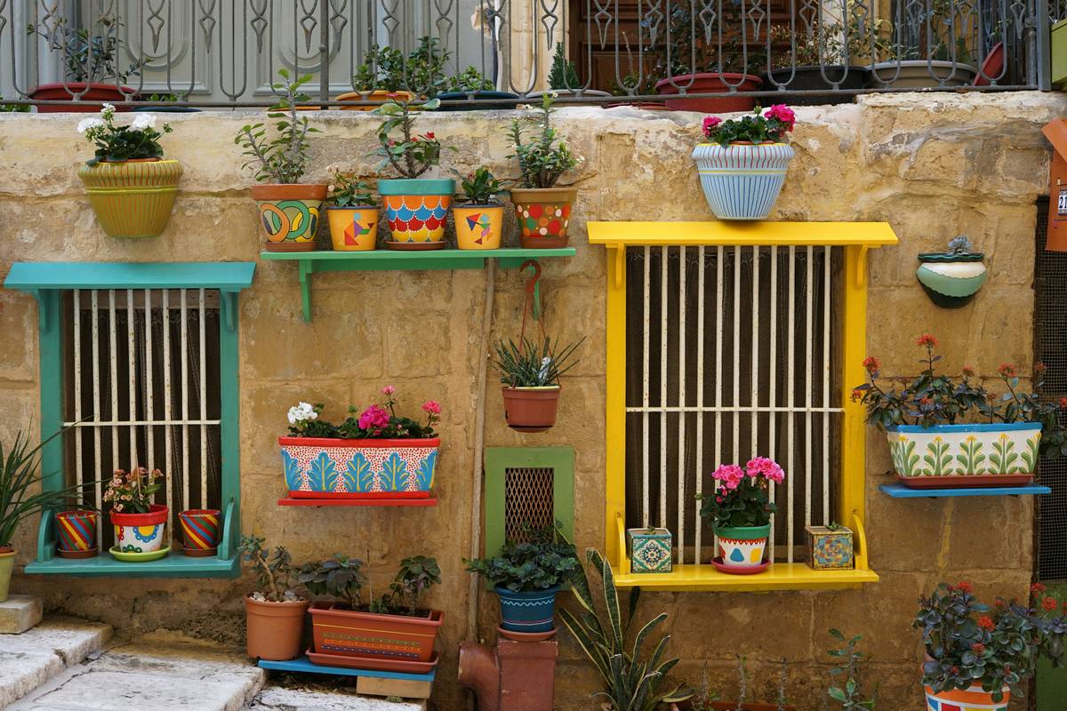 Wooden garden table on a patio with potted plants, showcasing practical garden tips and ideas